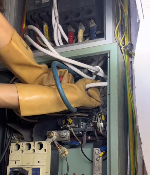 電工在配電箱內檢查主電纜